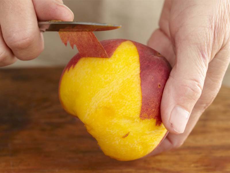 Peeling peaches with sparing knife